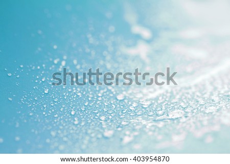 Close up the rain water drops on blue sponge surface as abstract background