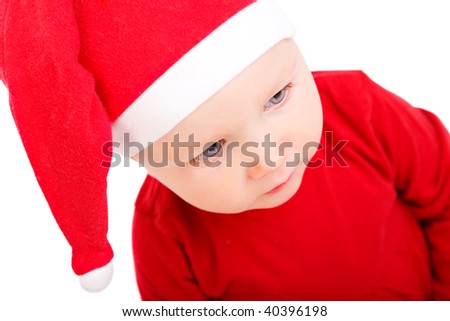 Portrait of Christmas baby girl in red Santa hat, isolated on white