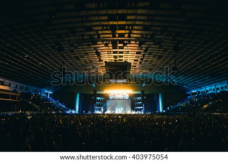 Large concert hall filled with spectators before the stage. Royalty-Free Stock Photo #403975054