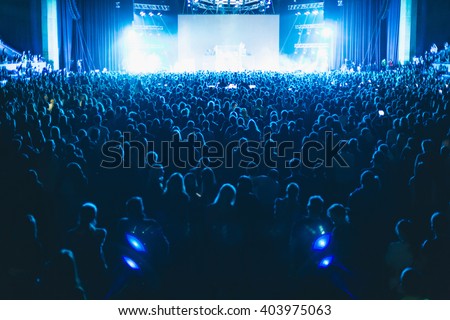 Large concert hall filled with spectators before the stage. Royalty-Free Stock Photo #403975063