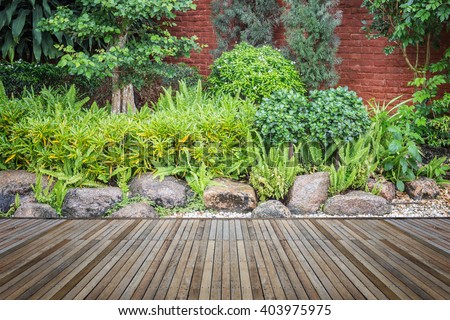 Old hardwood decking or flooring and plant in garden decorative Royalty-Free Stock Photo #403975975