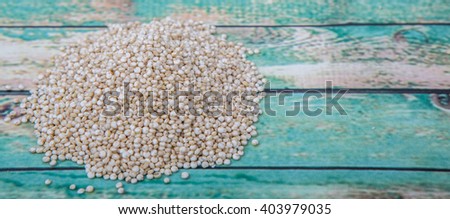 White quinoa grain over wooden background