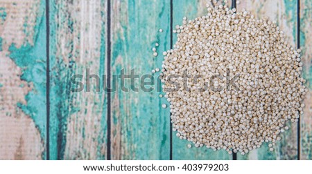 White quinoa grain over wooden background