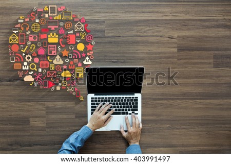 Business innovation technology set application icons, With businessman working on laptop computer PC on wood table, view from above Royalty-Free Stock Photo #403991497
