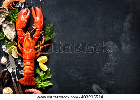 Shellfish plate of crustacean seafood with fresh lobster, mussels, shrimps, oysters as an ocean gourmet dinner background Royalty-Free Stock Photo #403995514