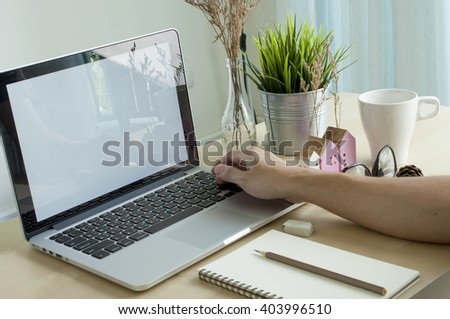 Business man push keyboard in front of laptop blank screen