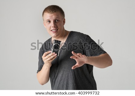 Portrait of happy male photographer on grey background