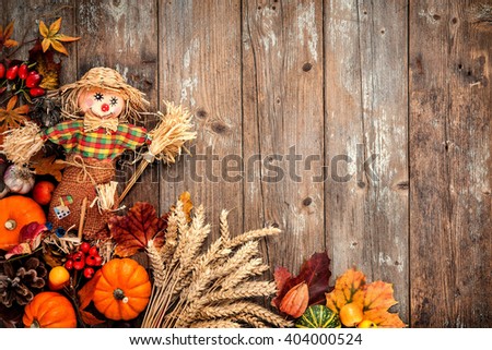 Colorful autumn background with a scarecrow decoration for Halloween and Thanksgiving