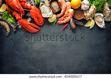 Shellfish plate of crustacean seafood with fresh lobster, mussels, oysters as an ocean gourmet dinner background Royalty-Free Stock Photo #404000617