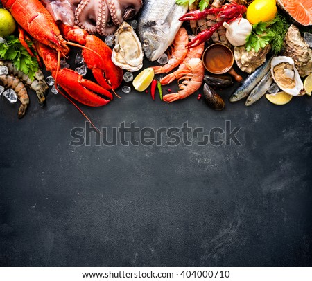 Shellfish plate of crustacean seafood with fresh lobster, mussels, oysters as an ocean gourmet dinner background Royalty-Free Stock Photo #404000710