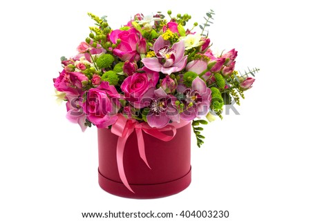 Flower arrangement in a hat box , a pot of pink for a girl on a gift with roses , orchids , freesia on a white background Royalty-Free Stock Photo #404003230