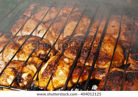 cooking chicken legs on fire stock photo
