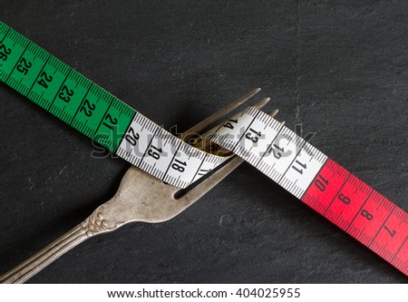 Italian food concept with centimeter and fork background