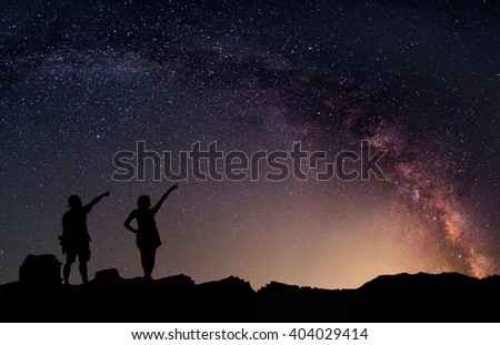 Star-catcher. A person is standing next to the Milky Way galaxy. Elements of this image furnished by NASA.