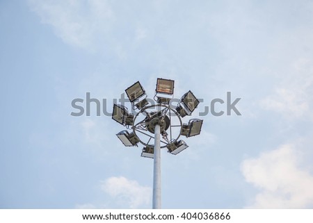 Sport lights with cloudy sky for background.