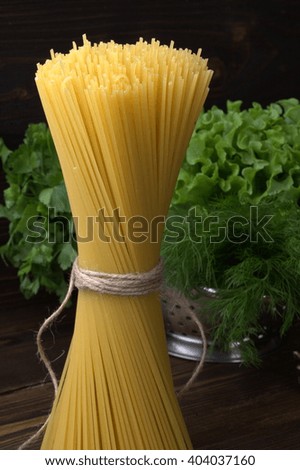 the picture in Studio photographed a bunch of pasta. vertical photos. in the background is the greenery of parsley and dill. Decorate the name of the dish to the restaurant menu.