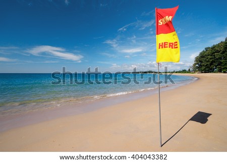Swim here, Safety flag on the sea beach.