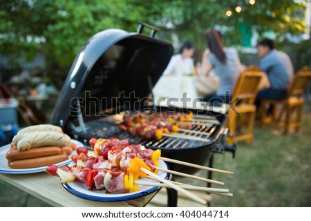 Dinner party, barbecue and roast pork at night Royalty-Free Stock Photo #404044714