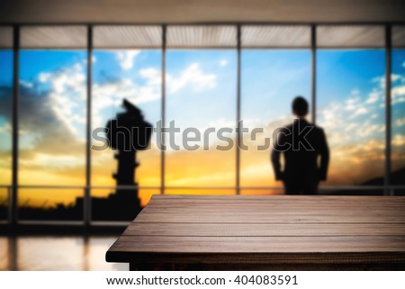 Desk space platform and business man standing in front of office window with tower and twilight sky sunset. For product display montage.