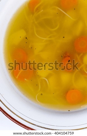 Flat lay image of homemade chicken soup in the plate.