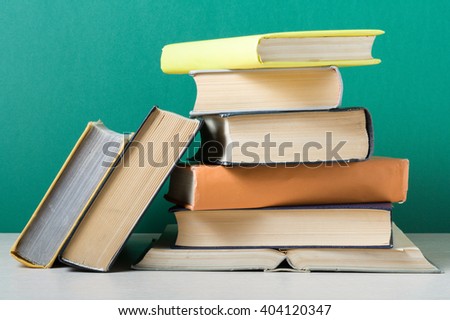 Stack of colorful books on wooden table. Education background. Back to school. Copy space for text.