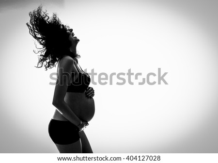Beautiful pregnant woman - isolated over a white background. Young happy woman enjoying motherhood. Suitable for Mother's Day