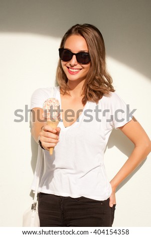 Portrait of a gorgeous happy brunette woman having summer ice cream fun.