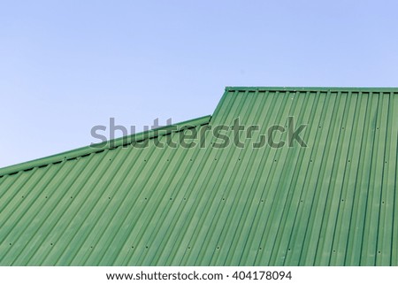 house, green roof tiles and blue sky