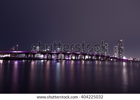 View on Miami Downtown and MacArthur Causeway at night time with a view on a bay, USA