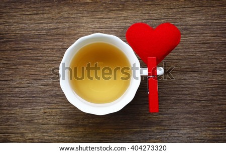 Tea cup of love concept.still life teacup and red heart on wooden table background.flat lay.(selective focus)
