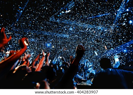 night party festival crowd of people silhouettes hands up with confetti Royalty-Free Stock Photo #404283907