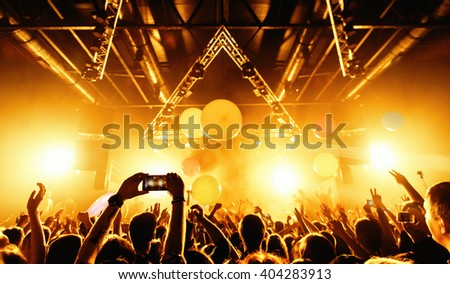 night party festival crowd of people silhouettes hands up Royalty-Free Stock Photo #404283913