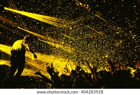 night party festival crowd of people silhouettes hands up with confetti Royalty-Free Stock Photo #404283928