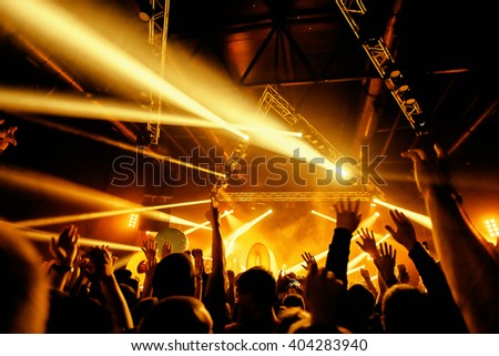 night party festival crowd of people silhouettes hands up Royalty-Free Stock Photo #404283940