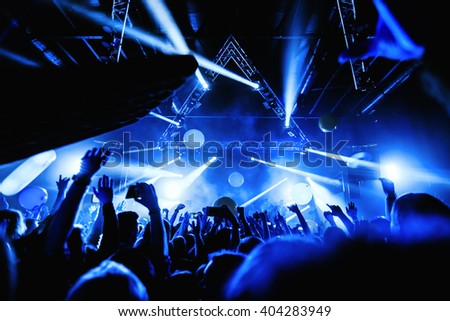 night party festival crowd of people silhouettes hands up Royalty-Free Stock Photo #404283949