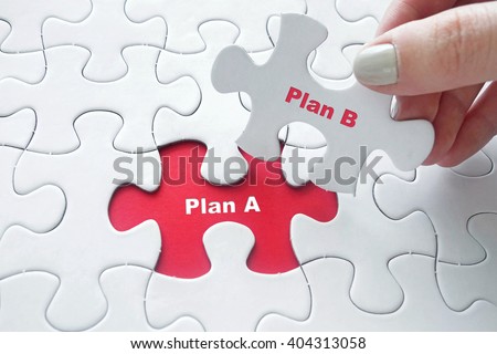 Close up of girl's hand placing the last jigsaw puzzle piece with word Plan A and Plan B as solution concept