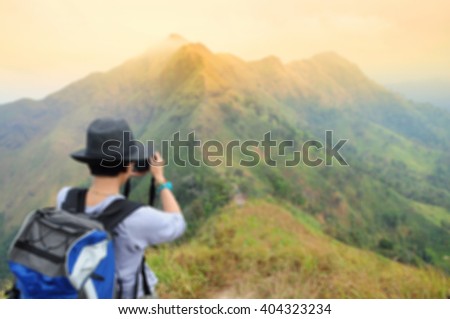 blurred woman take photo on mountain Khao Chang Puek, Thong Pha Phum National Park, Kanchanaburi, Thailand