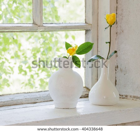 yellow roses on windowsill