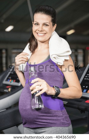 Smiling woman in sportswear at the gym