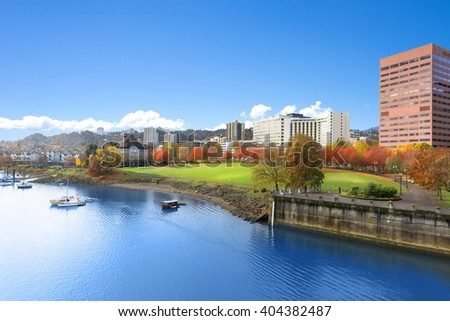 park near tranquil water with cityscape and skyline in portland