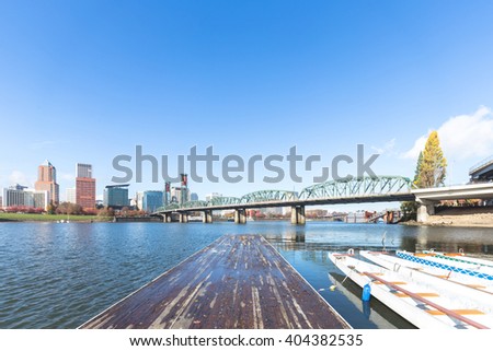 cityscape and skyline of portland on view from dirty wood planform of pier