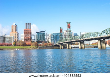 steel bridge over tranquil water with cityscape and skyline of portland 