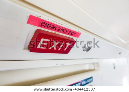 Emergency exit label and red sign sticker on aircraft door.Exit label put on top of door.Emergency Exit wording sign sticker is use for tell customer mostly on door in aircraft building and vehicle.