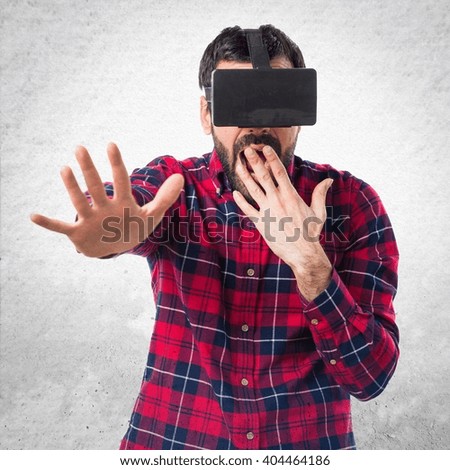 Man using VR glasses doing surprise gesture