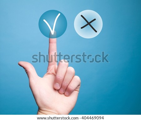 The hand presses the index finger on the circular transparent button with a check mark