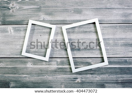 Two different see-through frames hanging on wooden wall. Mock up