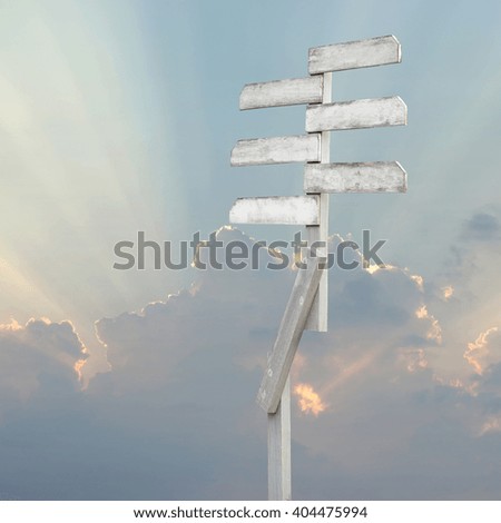 wooden direction sign with blank spaces for text on beautiful sunbeam background