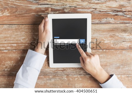business, people, search, web and technology concept - close up of male hands using internet browser on tablet pc computer and coffee cup at table