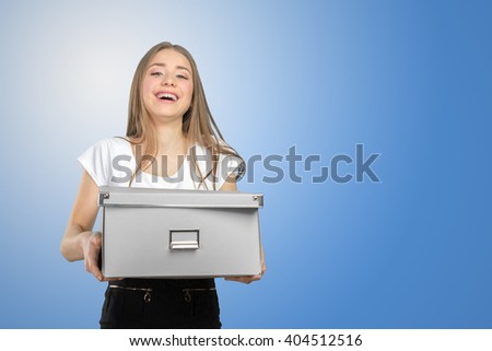 Young happy business woman with a box to move to a new office