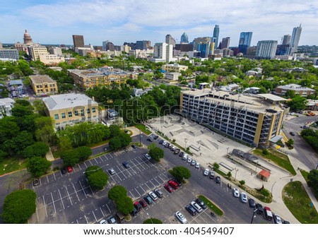 Austin Texas Aerial Shot Over House Skatepark near ACC Campus and the Texas State Capitol Building stands high on a hilltop with the Skyline Cityscape of the Austin Downtown area 